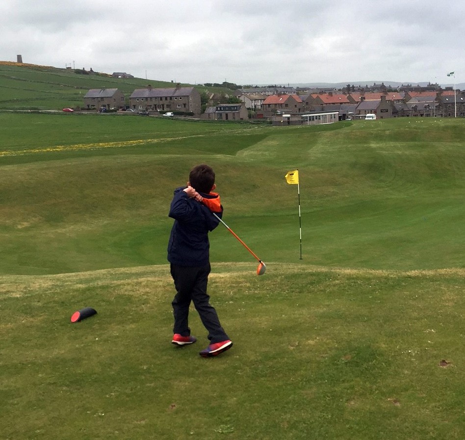 Young child learning golf during junior coaching at Dunes Golf Centre near Peterhead
