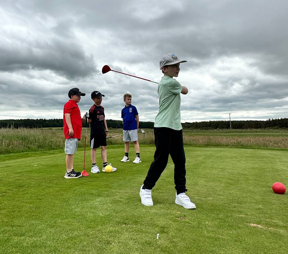 Junior golfer developing on-course skills during coaching at Dunes Golf Centre