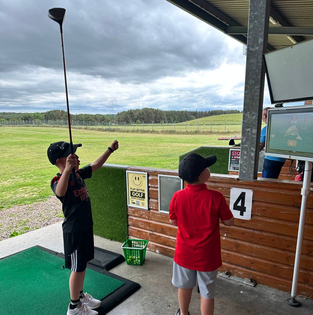 Junior Development Squad golfers practising on the driving range at Dunes Golf Centre